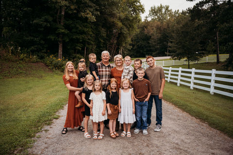 Grandparents and group of grandchildren smiling together.