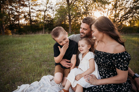 Parents, son, and daughter smiling together.