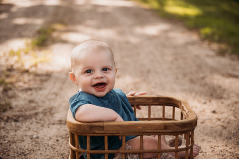 6 month boy smiling outside.