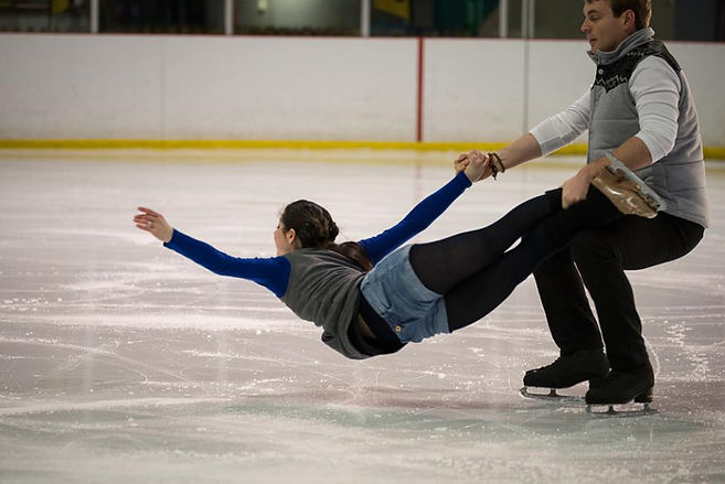 Two skaters, one in a lift