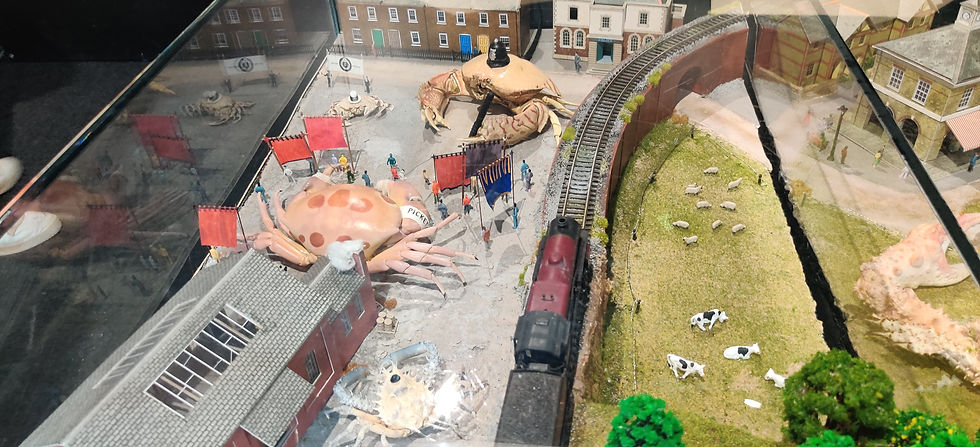 A police officer (Common Box Crab) violently suppressing the protest of a Spotted Reef crab factory worker. The Moon Crab depicts a fascist supporting the police while the factory owner (a Common Decorator Crab) hides from the commotion. Photo by Herre de Bondt.