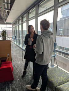 Two people talking and drinking coffee and tea