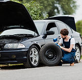 long-shot-man-swapping-tire.jpg