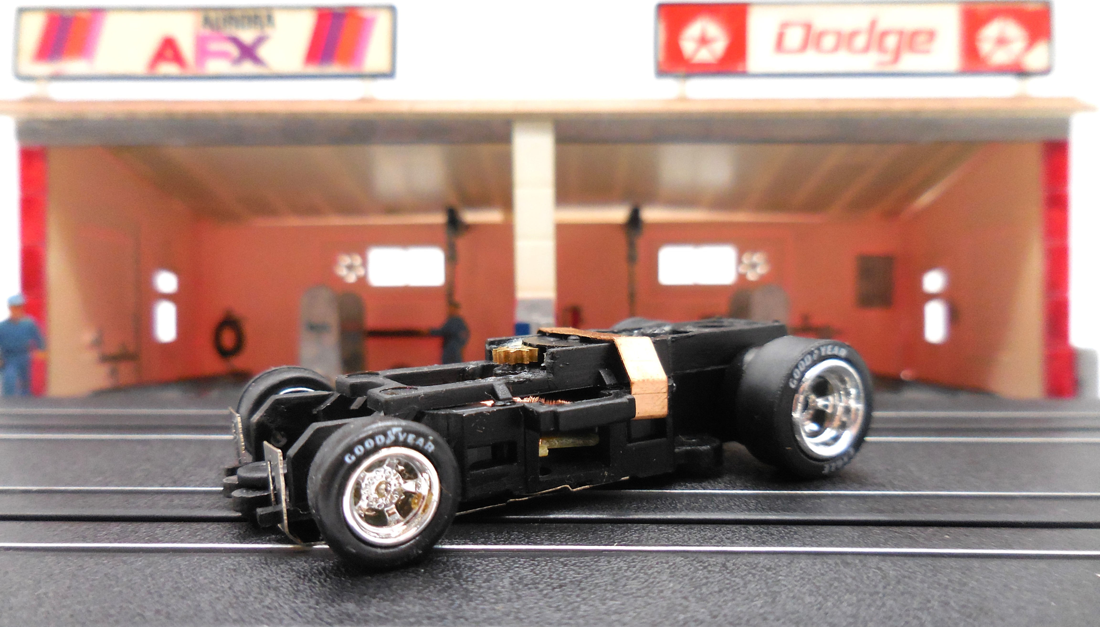 Auto World 1 Brand New 4 Gear Ultra G Chassis with Chrome Rims Goodyear Eagles