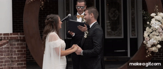 A couple kissing for a wedding video