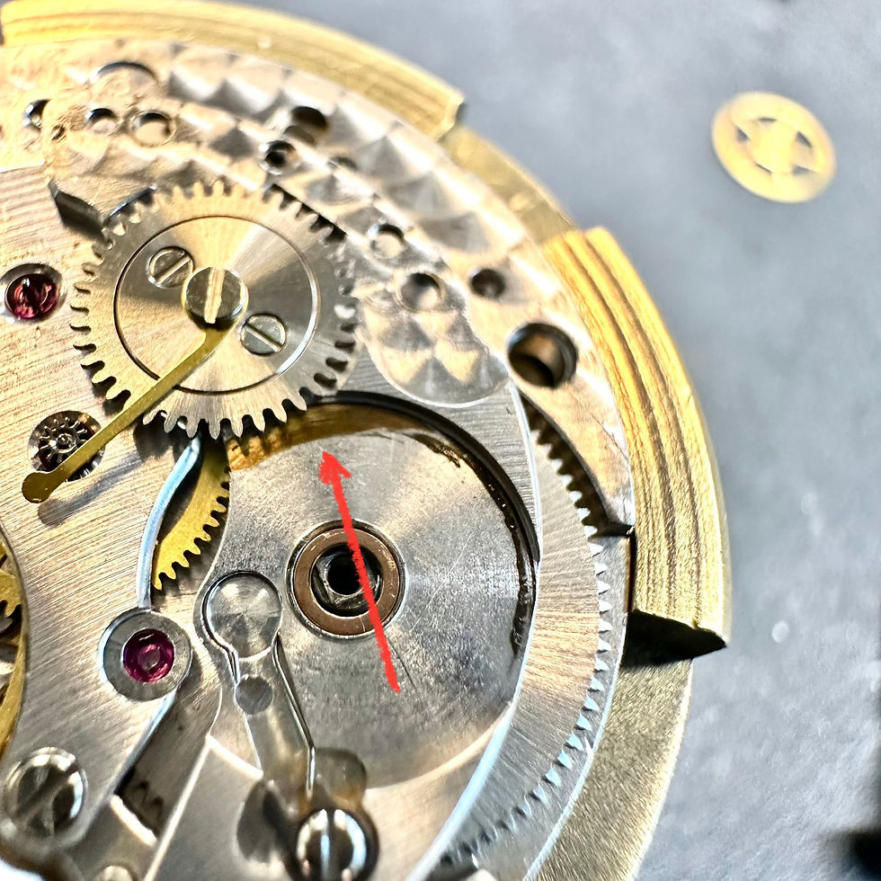 This upper bore hole machined improperly and now barrel tilts. The ratchet wheel (mounted above) now rubs on the top side of bridge. Look at the wear marks on the bridge (red arrow). Yikes