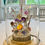 Thumbnail: Handmade Flower Dome ft. homegrown blooms, encased in a glass dome with brass base on event table