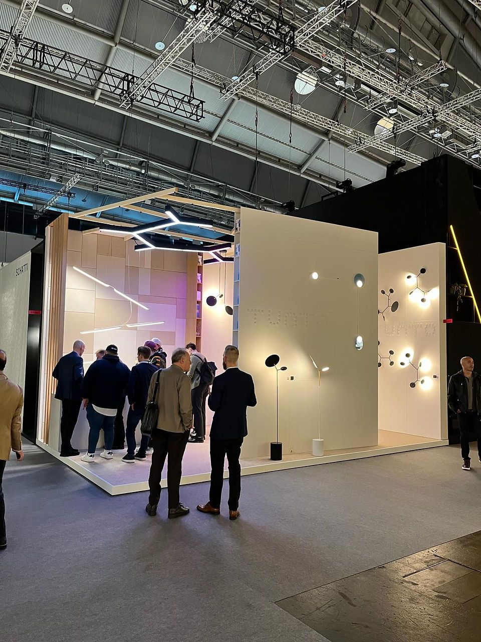 Guests visiting Tunto Lighting's booth during Light + Building Fair 2024 in Frankfurt, Germany.