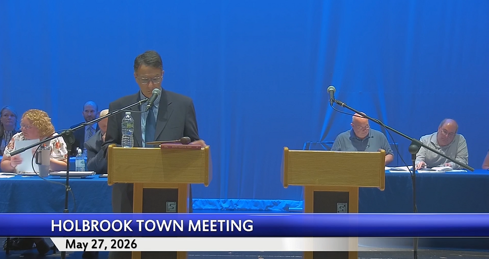 Town Moderator James J. Curran stands at the podium to run the May 27th Town Meeting