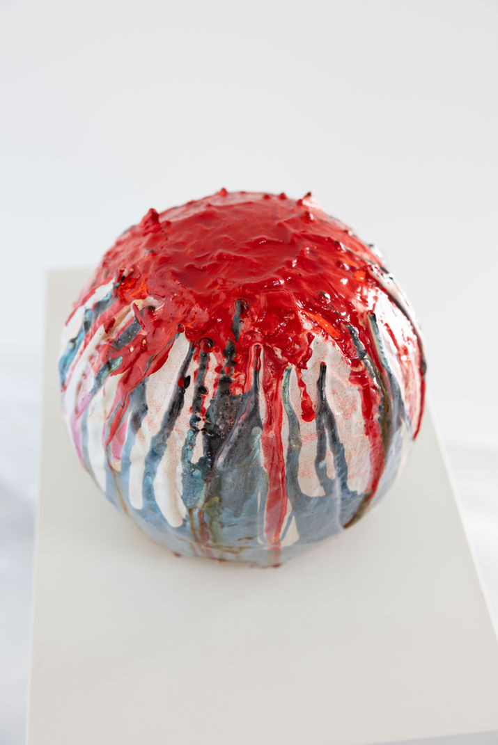 Round sculptural artwork with flowing lines and layered color. Its circular form represents the power of the full moon. The flowing colors and dripping lines suggest the different phases of the moon. They reflect the moon’s magical presence and the many myths surrounding it.