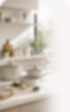 A modern white cookware set on a stylish kitchen countertop