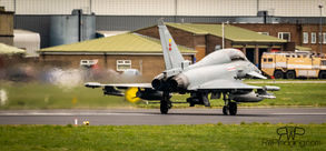 Jet plane on runway, preparing for takeoff, seen from behind, close up.