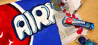 Man and woman laugh happily while working together with clay at a pottery wheel