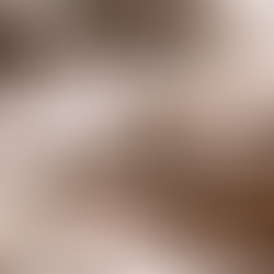 Hand carefully shapes fresh clay in an art studio with tools in the background