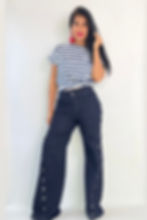 Woman in striped top and dark wide-leg button pants