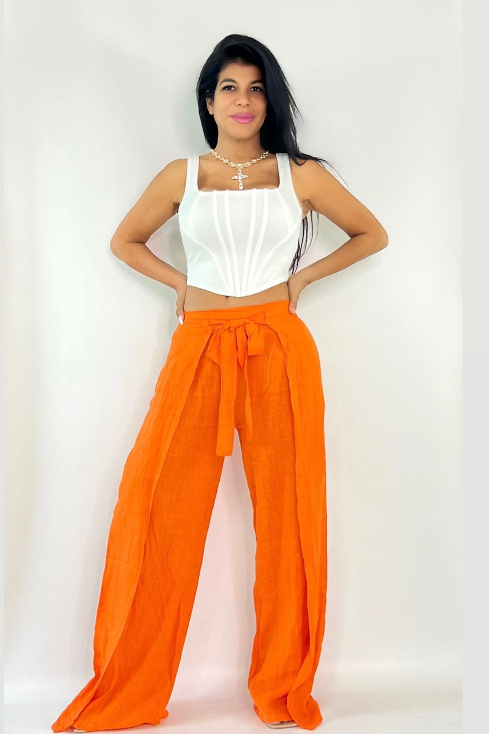 Thumbnail: Woman wearing white corset top and orange pants