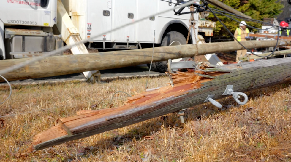 Broken utility pole during power and fiber construction project