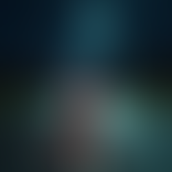 A person riding their motorcycle at night