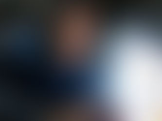 A man looking at a bottle of motorcycle engine oil