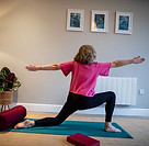Vicky doing a kneeling Warrior II pose.