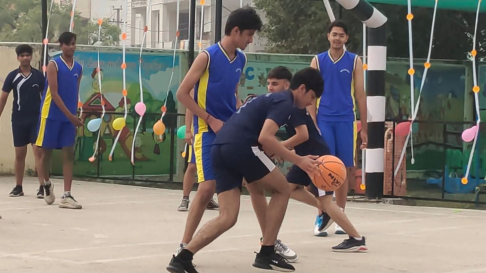 Students playing basketball outdoors on a court during a game.