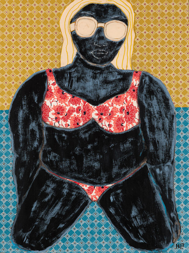 Woman in a bathing suite posing on a beach