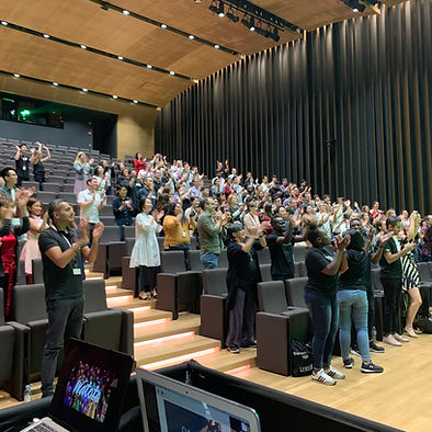 A picture of an audience attending to a conference