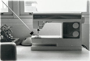 Photo of a sewing machine in front of a window