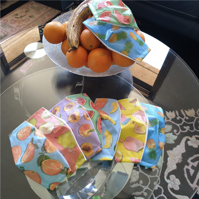Freshly printed colorful custom face mask designs laid out on a kitchen counter.