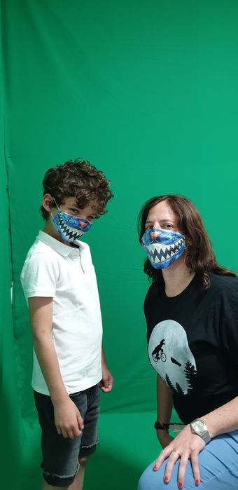 Woman and young boy modeling matching custom face masks during a home photoshoot.