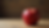 Close-up view of a fresh red apple on a wooden table