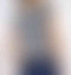 Wearing a black and white crocheted houndstooth crew neck vest from the back