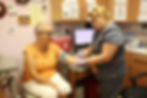 Healthcare professional drawing blood from an older patient during a blood pressure and heart health evaluation.