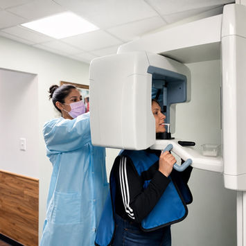 Dental assistant performing a digital panoramic dental X-ray at Avalon Dental Center in Cambridge, MA