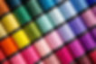 Close up Background Spool of sewing threads colorful sort in diagonal..jpg