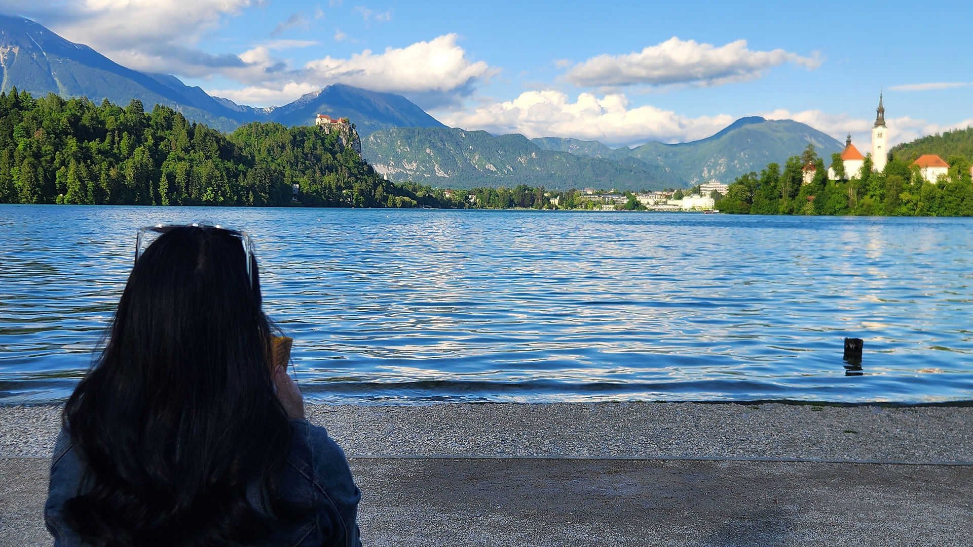 A woman gazing at a lakeside view.