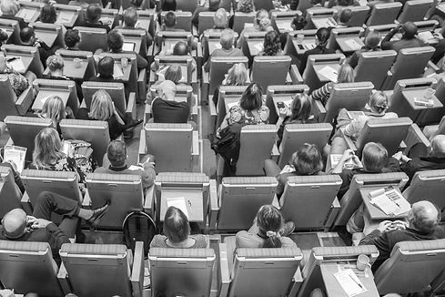 Aerial view of conference delegates sitting in chairs