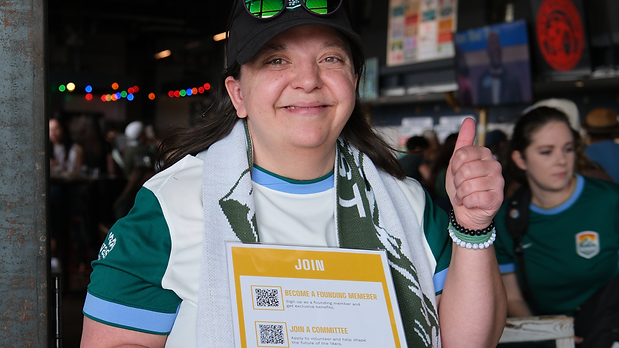 photograph of person wearing team merchandise, smiling