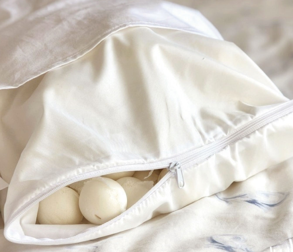 Close-up of a pillow with the zipper partially open, showing the latex balls.