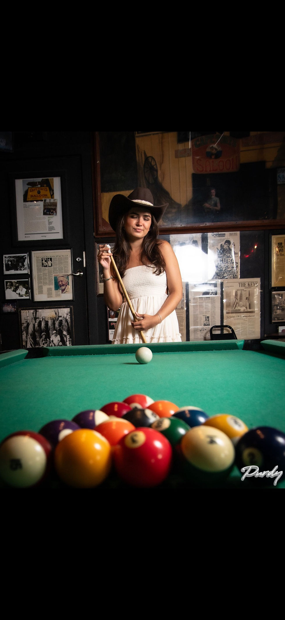 Maggie Thompson music artist posing with pool cue and balls