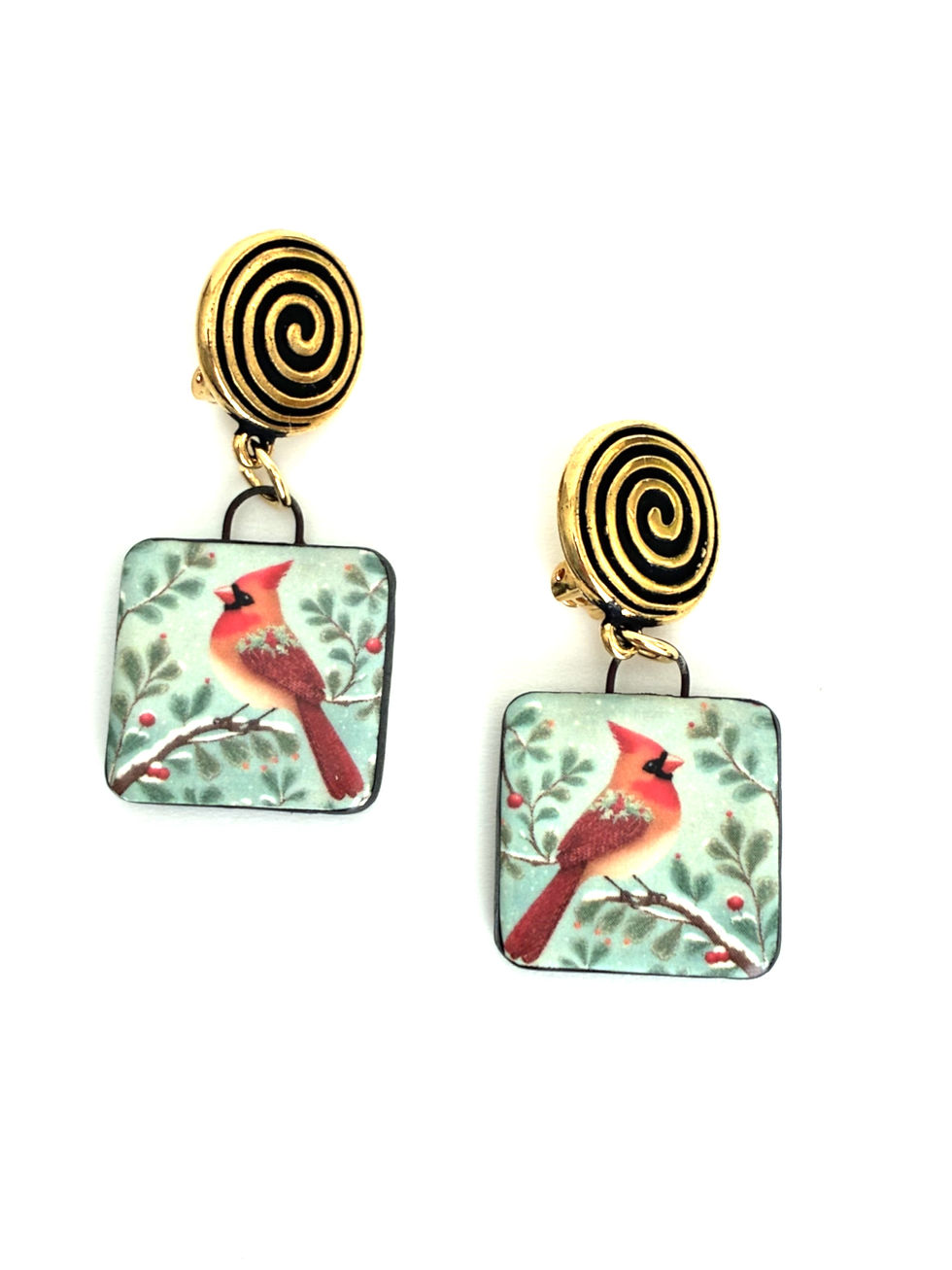 Image shows two clip-on earrings with bird motif with green and white background.