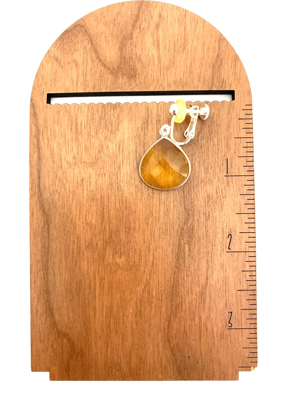 Thumbnail: Yellow teardrop earring on wood display with ruler marks