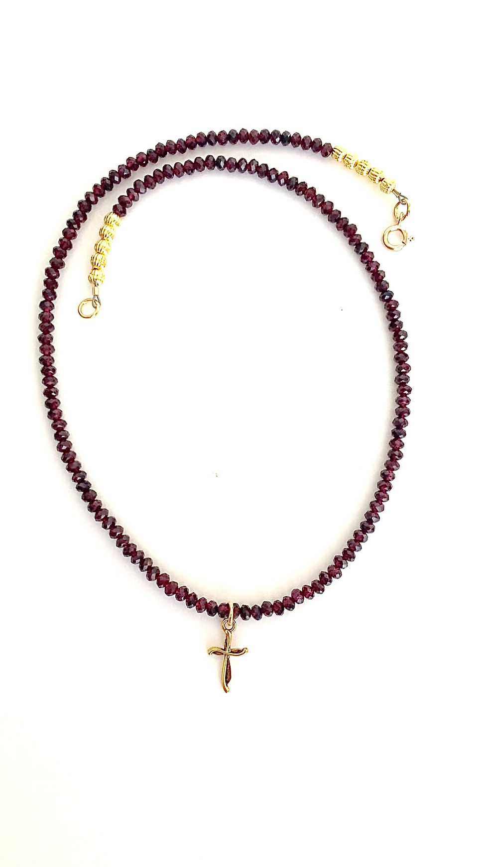Thumbnail: A video of a dainty gold plated cross necklace with garnet gemstone