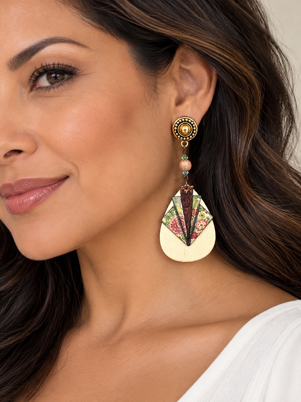 Image of one statement earring on a female model with long dark hair.