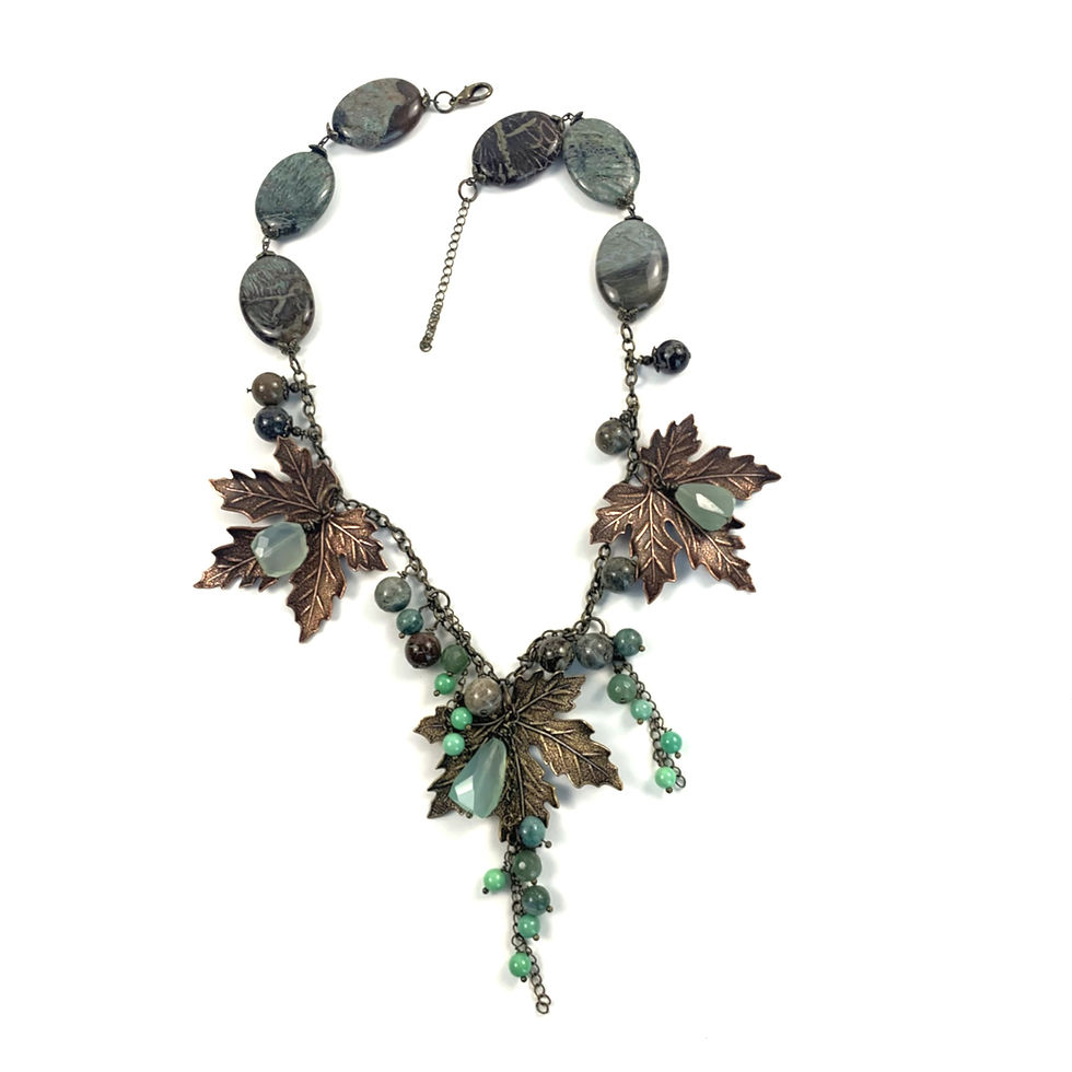 Thumbnail: Handcrafted metal necklace with leaf design and green stones