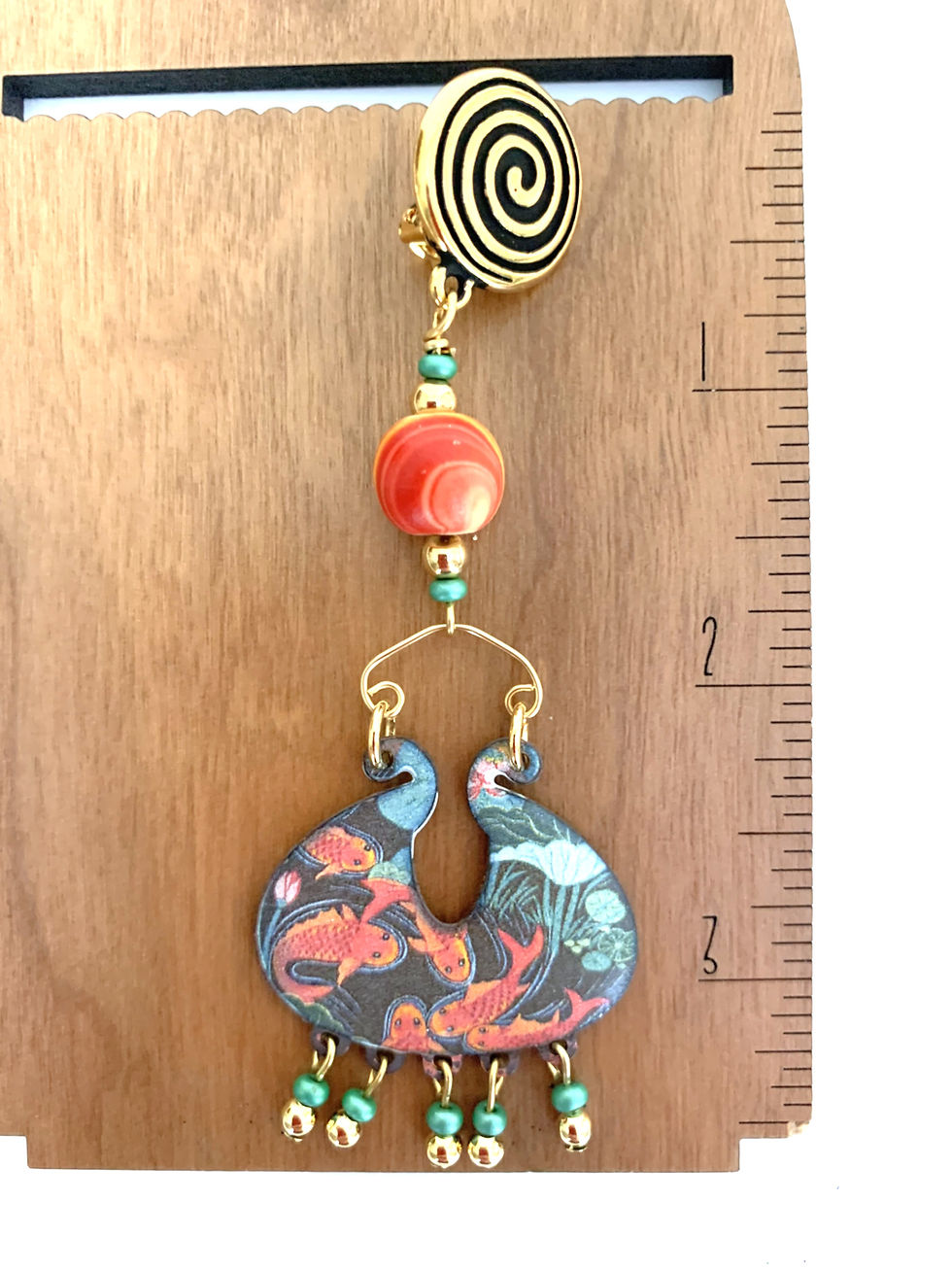 Thumbnail: Handcrafted dangle earring with spiral clip and patterned pendant