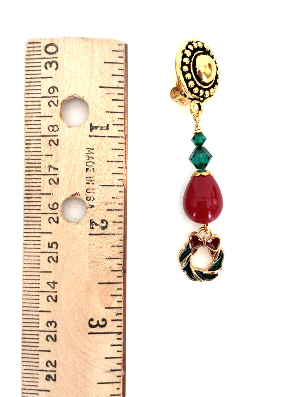 Thumbnail: Image of one Christmas earring next to a wooden ruler indicating the 2.5 inch length.