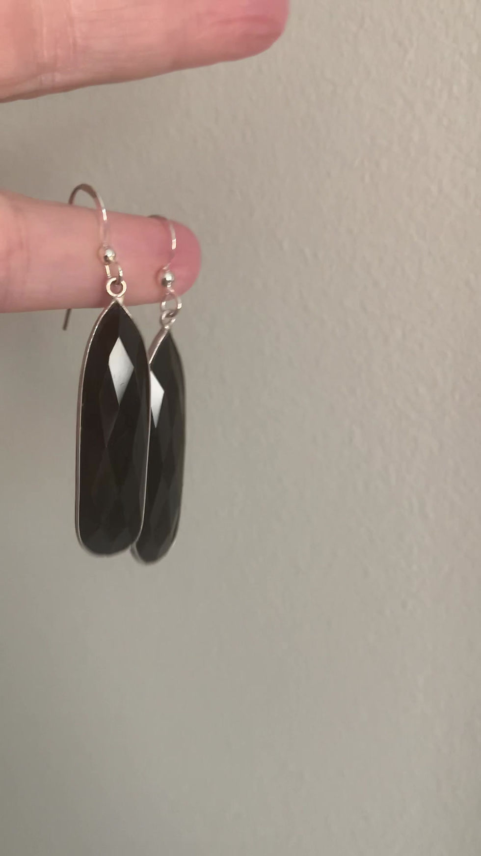 Thumbnail: A video of a pair of minimalist black Onyx bar earrings, long and faceted stones