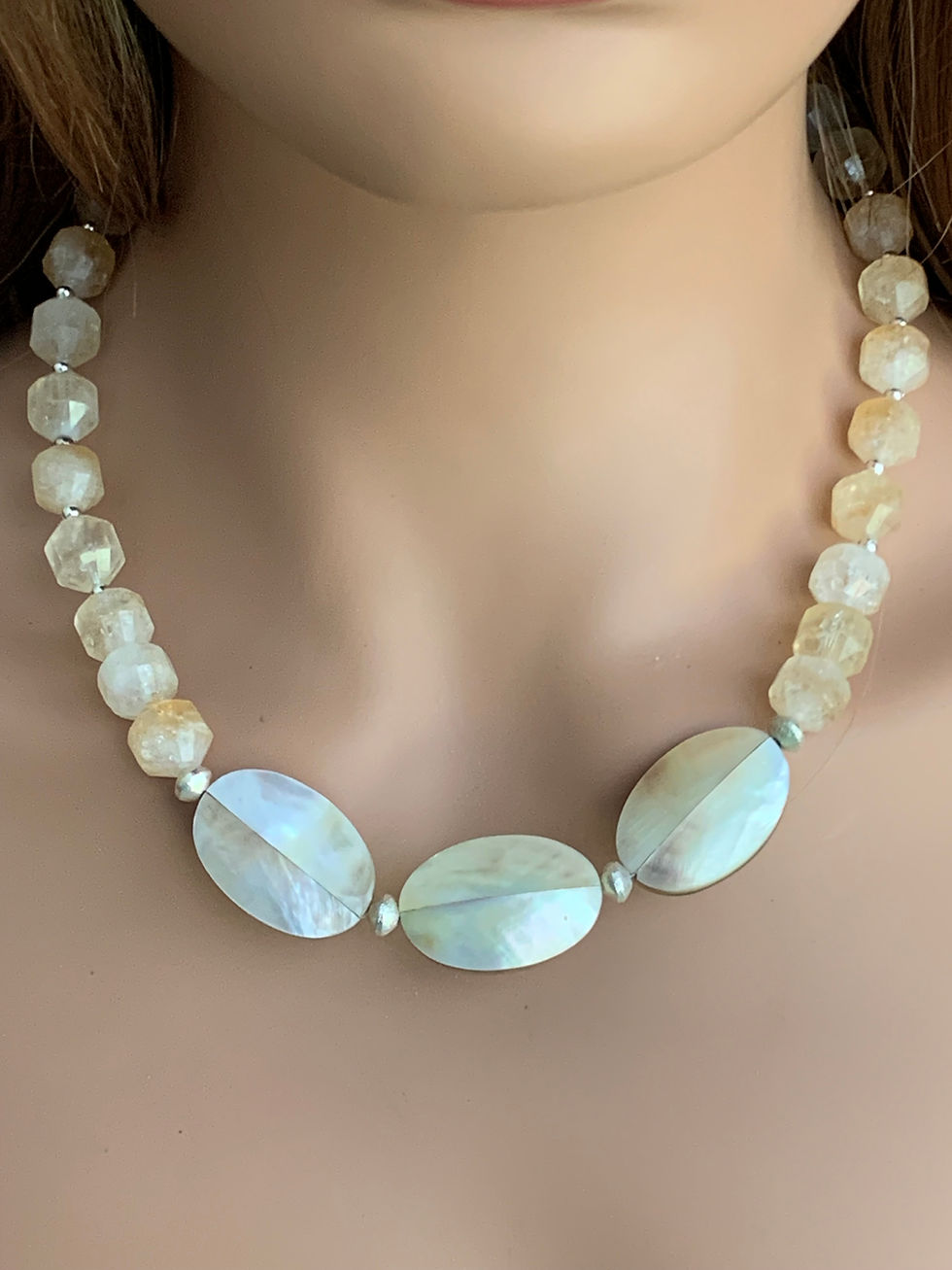 Thumbnail: Light-colored necklace with large oval and smaller faceted beads