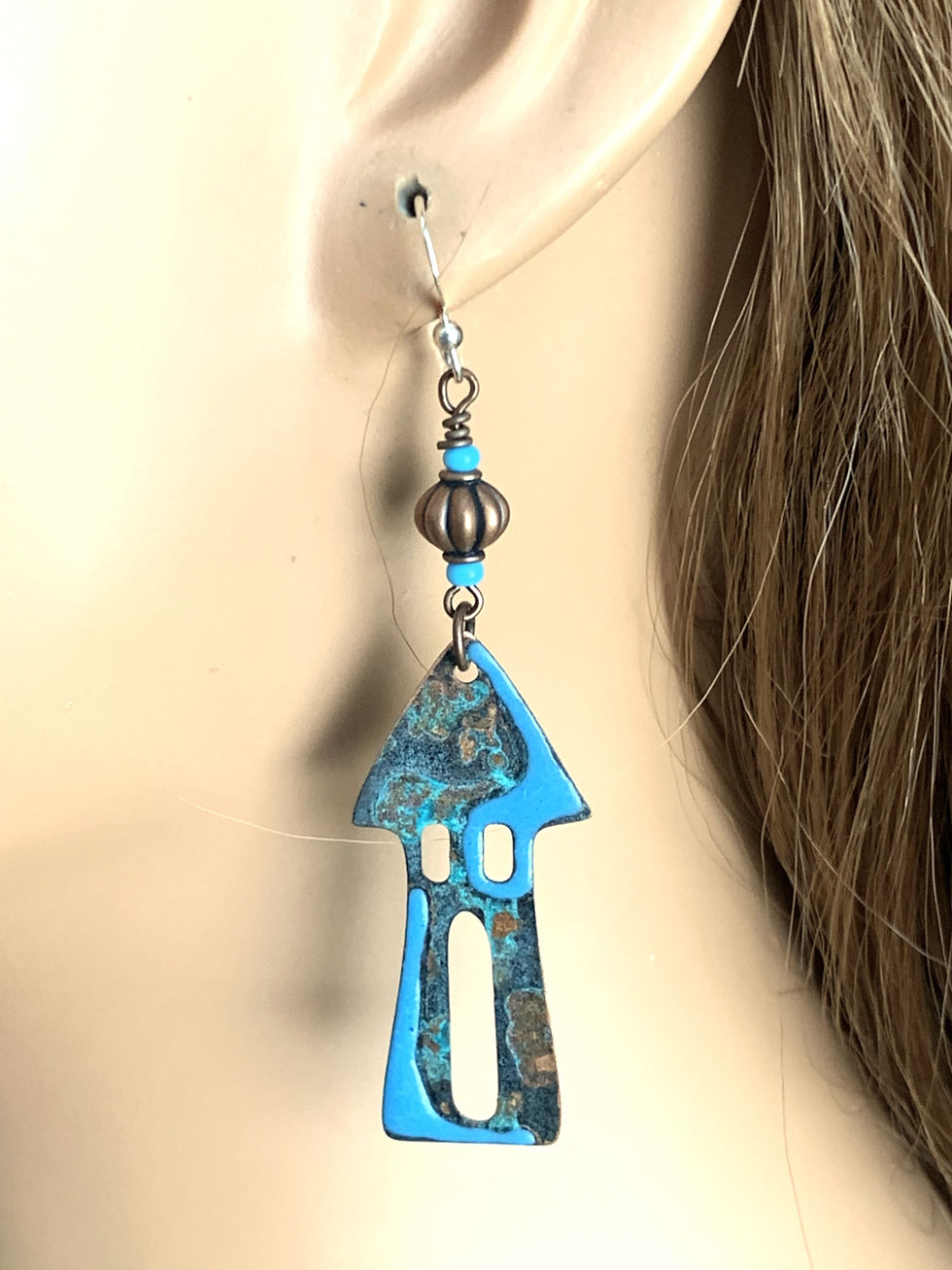 Thumbnail: Blue and copper house-shaped earring on ear